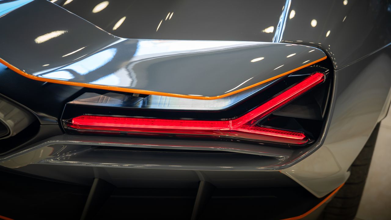 Detailed shot of a luxury cars rear tail light with sleek design and modern look.